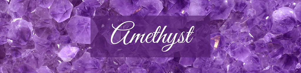 An expansive, close-up view of numerous amethyst crystals with a panoramic, wide format. The crystals vary in shade from light lavender to deep purple, showcasing their natural, multifaceted surfaces that gleam with a crystalline sparkle. Overlaying the centre is the word "Amethyst" in a cursive, elegant white font, contrasting beautifully against the rich purple background of the gemstones. The overall effect is one of abundance and splendour, highlighting the beauty and depth of the amethyst crystals.