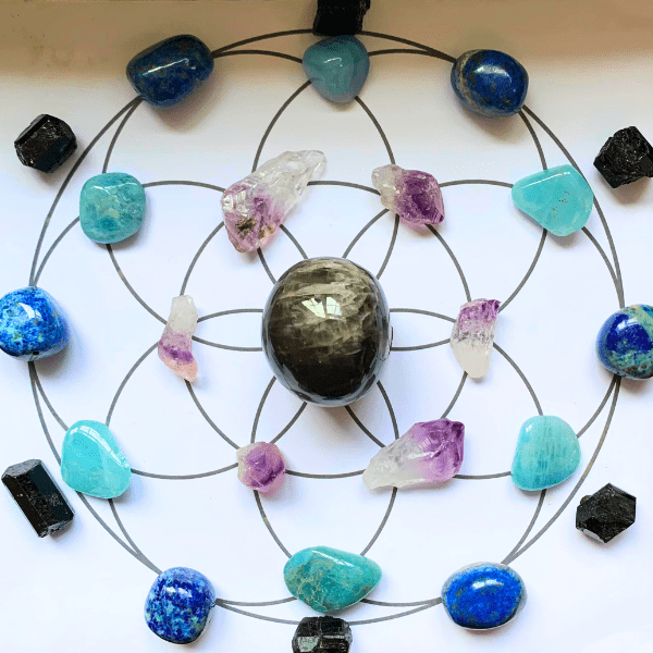 Seed of Life crystal grid for New Moon in Pisces, with black moonstone, amethyst, aquamarine, sodalite and black tourmaline crystals
